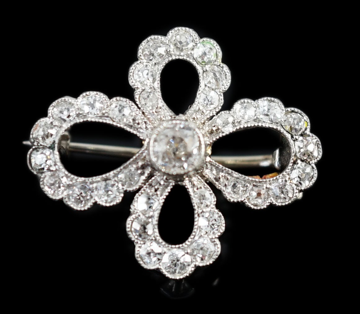A 1940's white gold? and millegrain set diamond cluster set open work quatrefoil shaped brooch